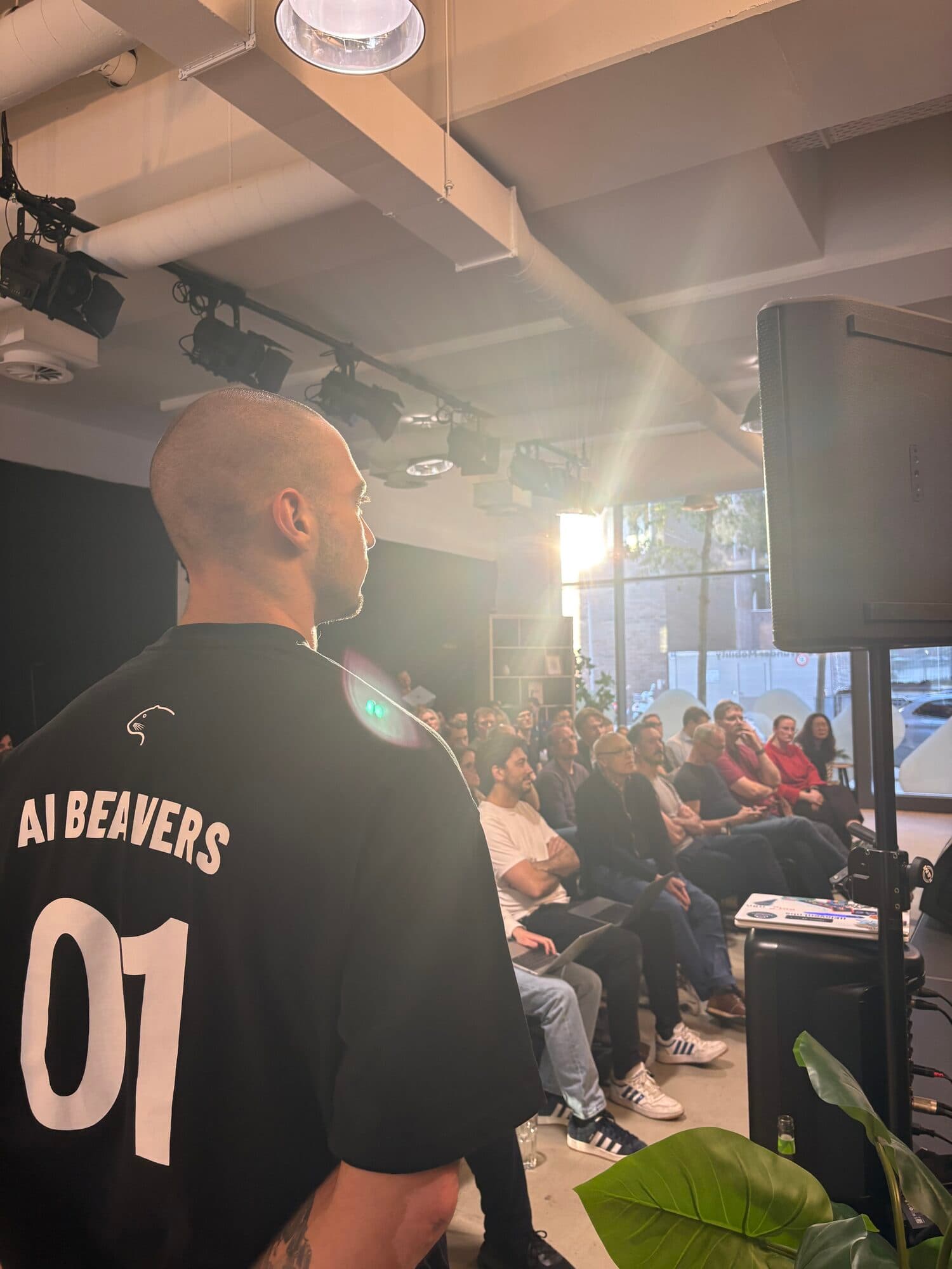 A host in an AI BEAVERS jersey with the number 01 at a busy event