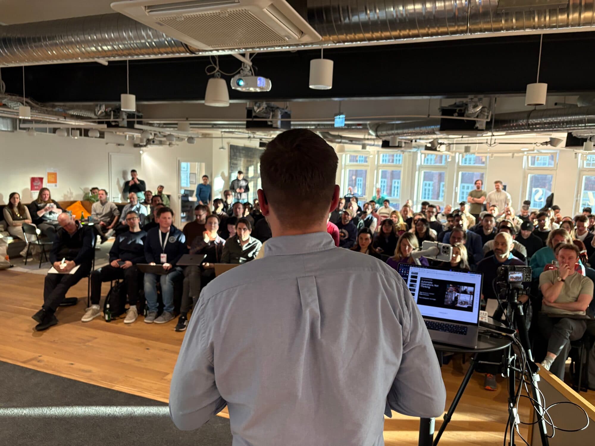 A speaker presenting to a packed room at an AI BEAVERS event
