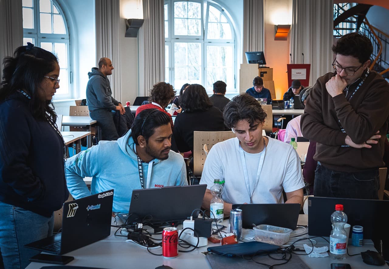 A full room of teams building on laptops during the AI BEAVERS January 2026 hackathon in Hamburg