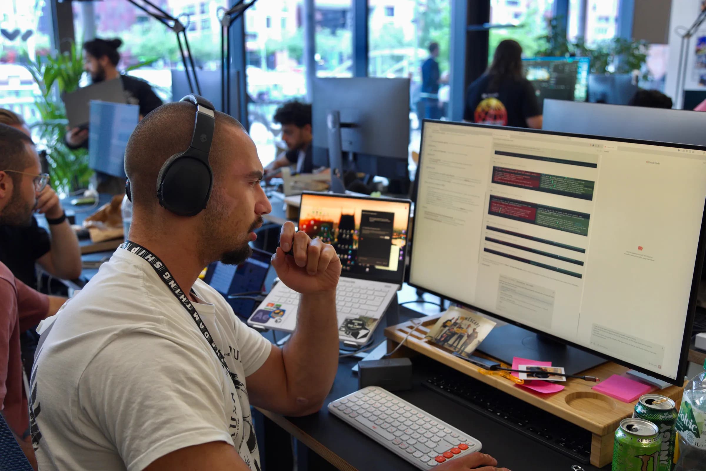 A founder in headphones concentrating at his monitor during the AI BEAVERS Founder Hackathon in Hamburg