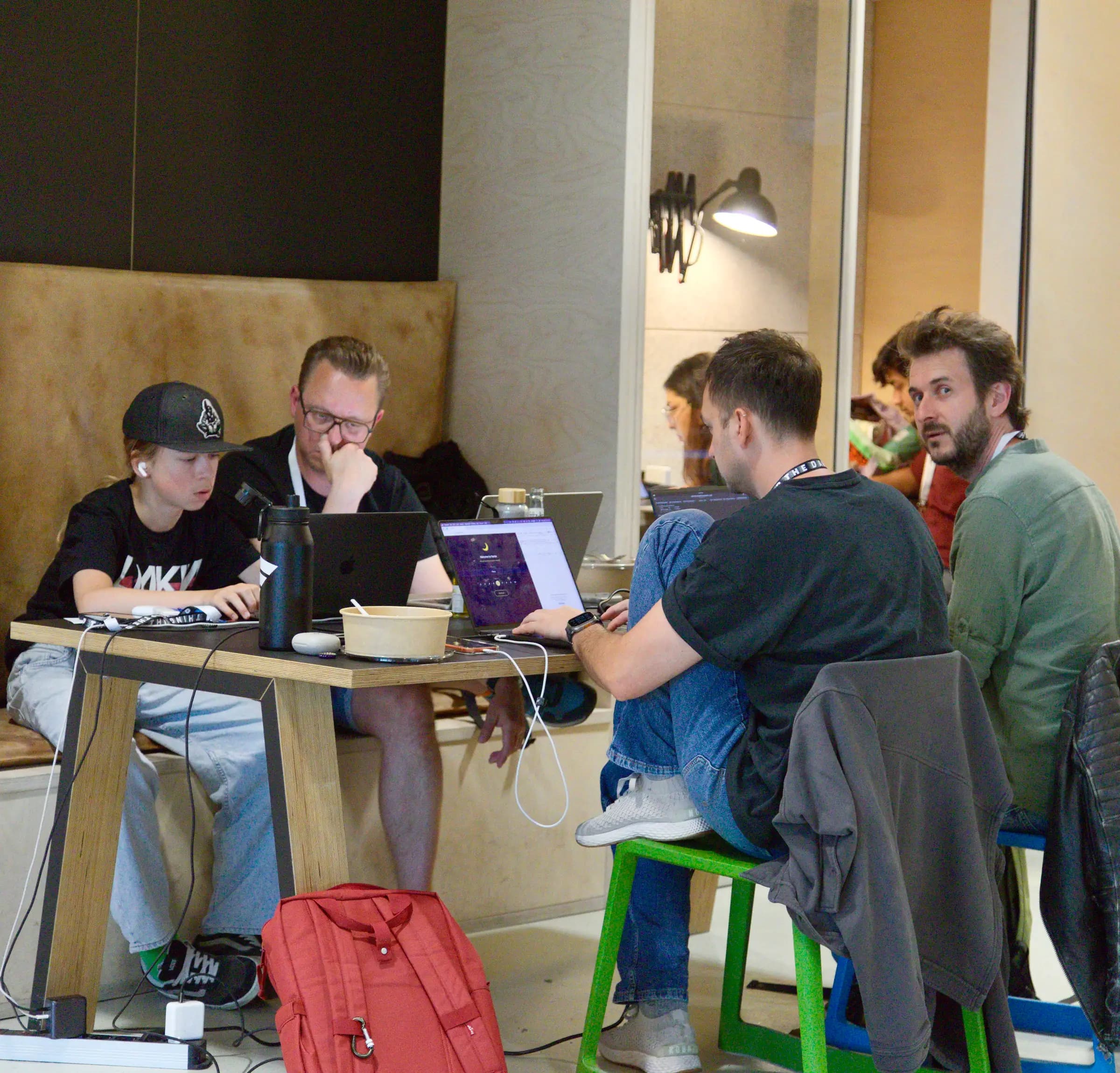 A long table of founders listening and taking notes at the AI BEAVERS Founder Hackathon in Hamburg