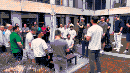 AI BEAVERS members gathered outdoors in a courtyard, drawn in pixel art